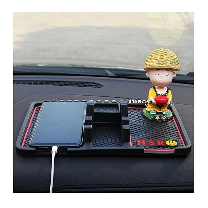 Car dashboard with a phone holder, figurine, and smartphone
