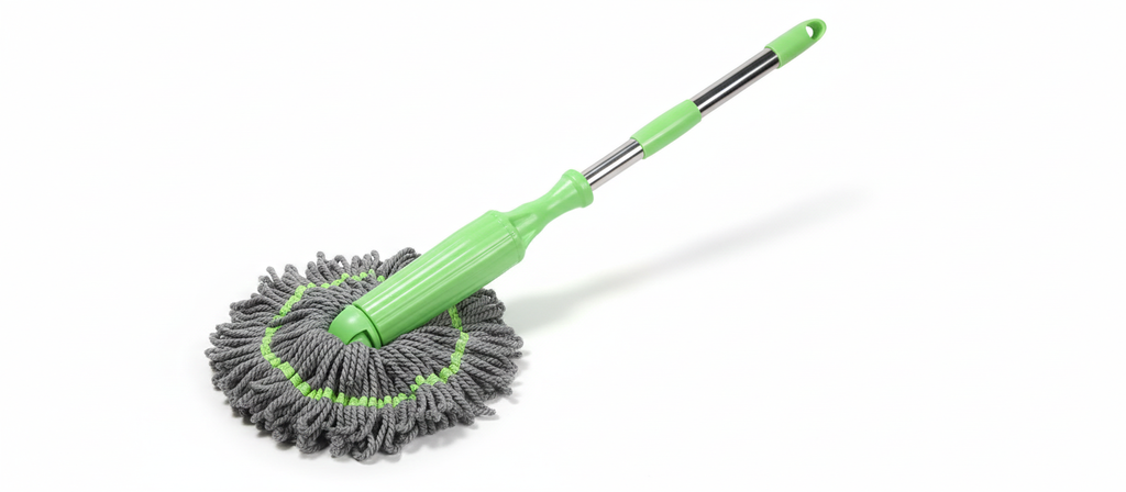A green and grey mop with a circular mop head and a telescoping handle is displayed against a white background, casting a slight shadow.