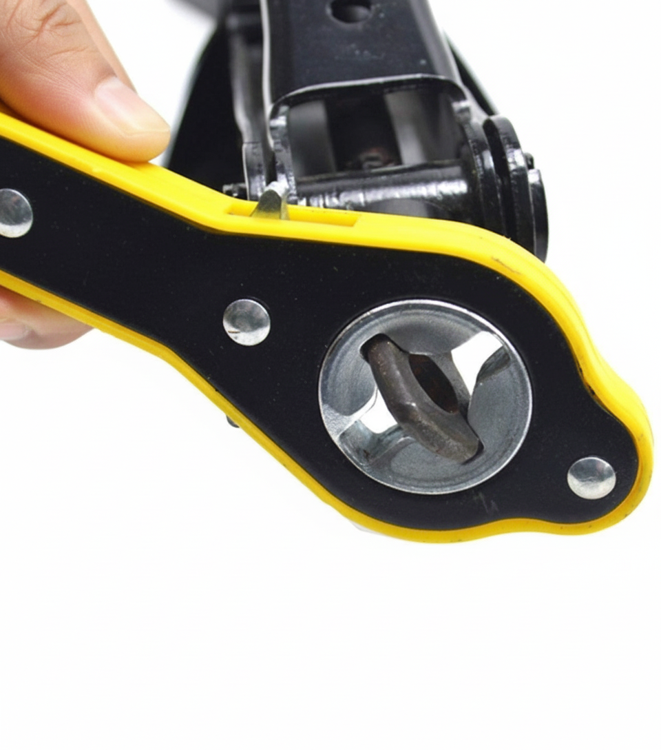 A hand holds a yellow and black ratchet wrench, focused on its socket end.
