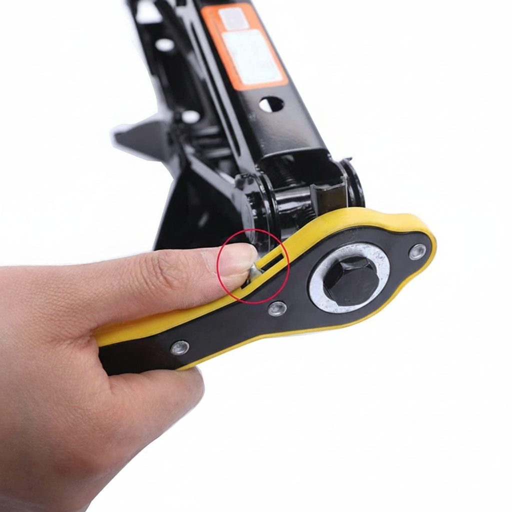 A person's hand operates a yellow and black ratchet handle attached to a black scissor jack, all against a white background.
